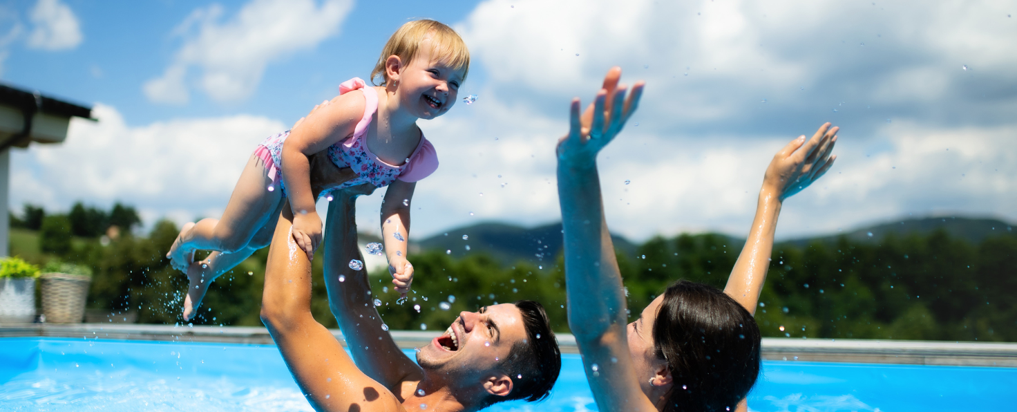 Happy-couple-playing-with-child-in-pool